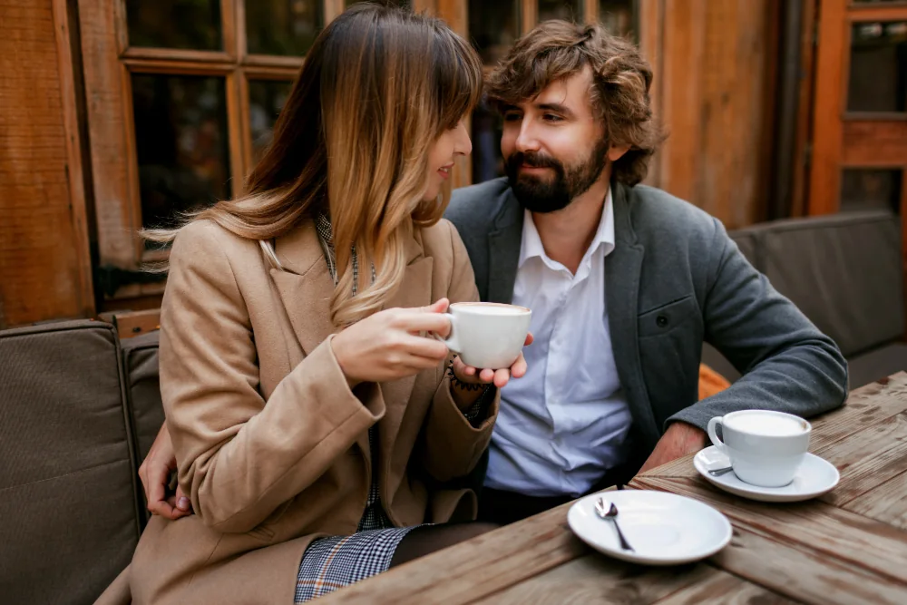 A couple sharing coffee on a café date